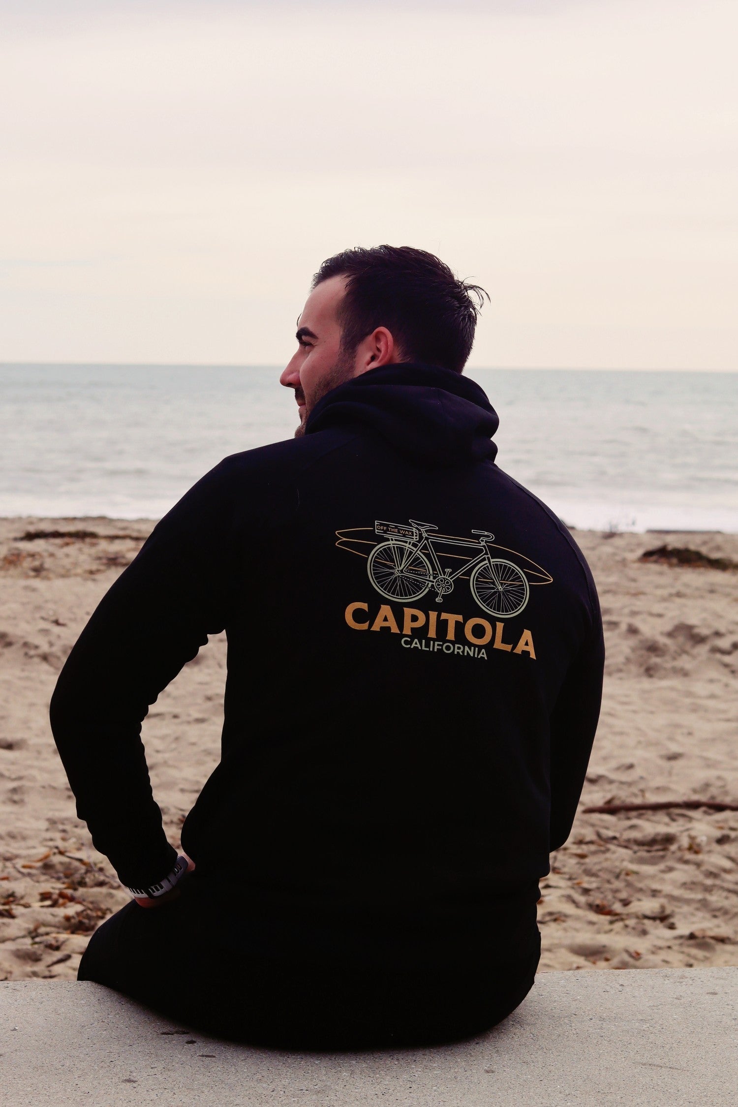 Capitola Bike hoodie on the sand at Capitola