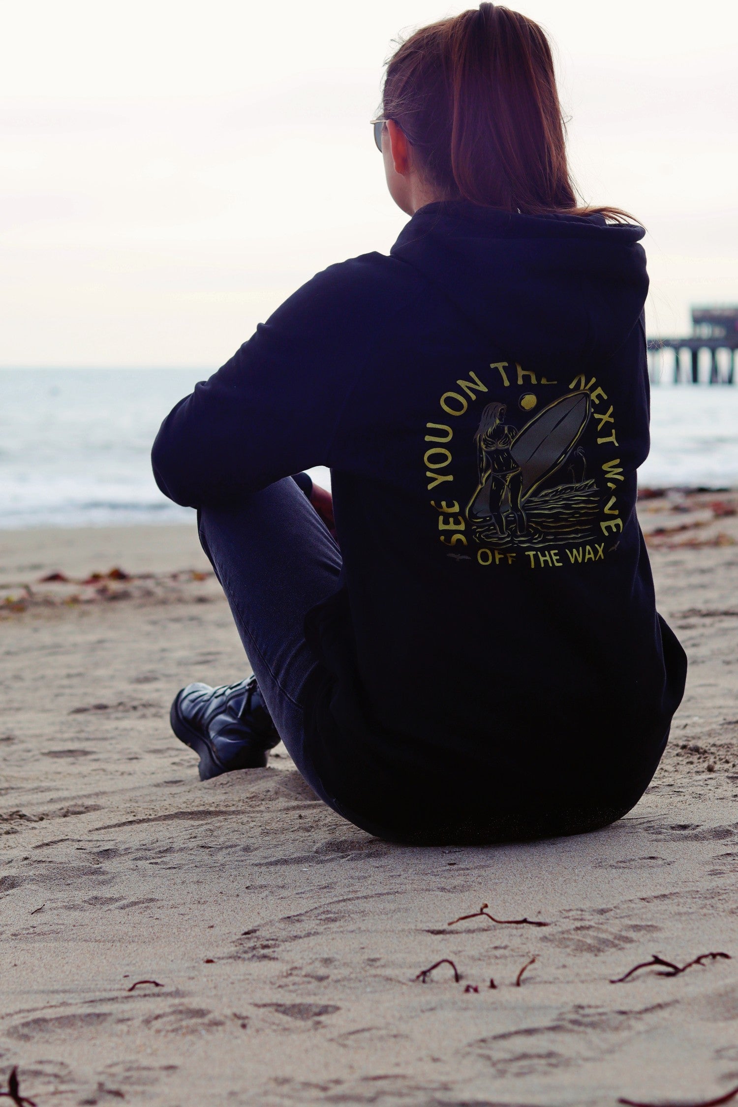 Next Wave hoodie on the sand, Capitola wharf behind